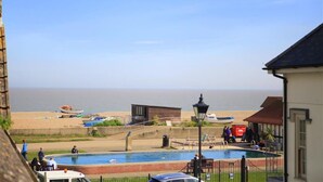 A coastal view with a swimming pool, beach, and ocean. - 4 Bed in Aldeburgh (oc-sfhan7) (Aldeburgh)
