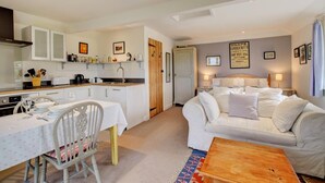 A compact living space with a kitchenette, a dining area, and a bedroom. - 2 Bed in Snape (oc-sfoms) (Snape)