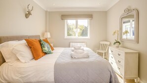 A bedroom with a bed, pillows, a dresser, a chair, a window, and a wall-mounted mirror. - 2 Bed in Halesworth (oc-dak) (Halesworth)