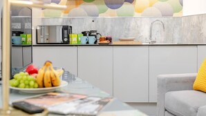 A modern kitchen with a microwave, coffee maker, and fruit bowl. - 1 Bed in Penzance (oc-u34132) (Penzance)