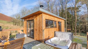A wooden cabin with a hot tub, deck, and outdoor seating. - 1 Bed in Newton In Bowland (oc-h34064) (Newton)