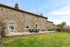 A stone building with a patio area, a table, and benches. - 4 Bed in Low Row (oc-h34097) (Crackpot)