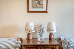 A wooden table with two lamps and a vase with greenery. - 4 Bed in Low Row (oc-h34097) (Crackpot)