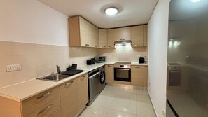 Superior Apartment, Balcony, Pool View | Private kitchen | Fridge, microwave, oven, stovetop - Zavos Aqua Park Club Apt by TrulyCyprus (Mouttagiaka)