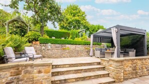 A patio with stone steps, outdoor furniture, and a pergola. - 5 Bed in Scalby (oc-sa871) (Scalby)