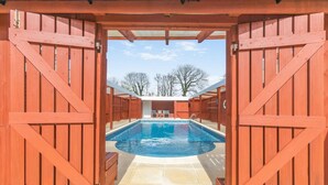A pool area with wooden gates, a tiled floor, and a clear sky. - 3 Bed in Nr St. Keverne (oc-tremen) (Saint Keverne)