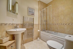 A bathroom with a sink, toilet, shower, and a towel rack. - 2 Bed in Ilfracombe (oc-sunviw) (Ilfracombe)