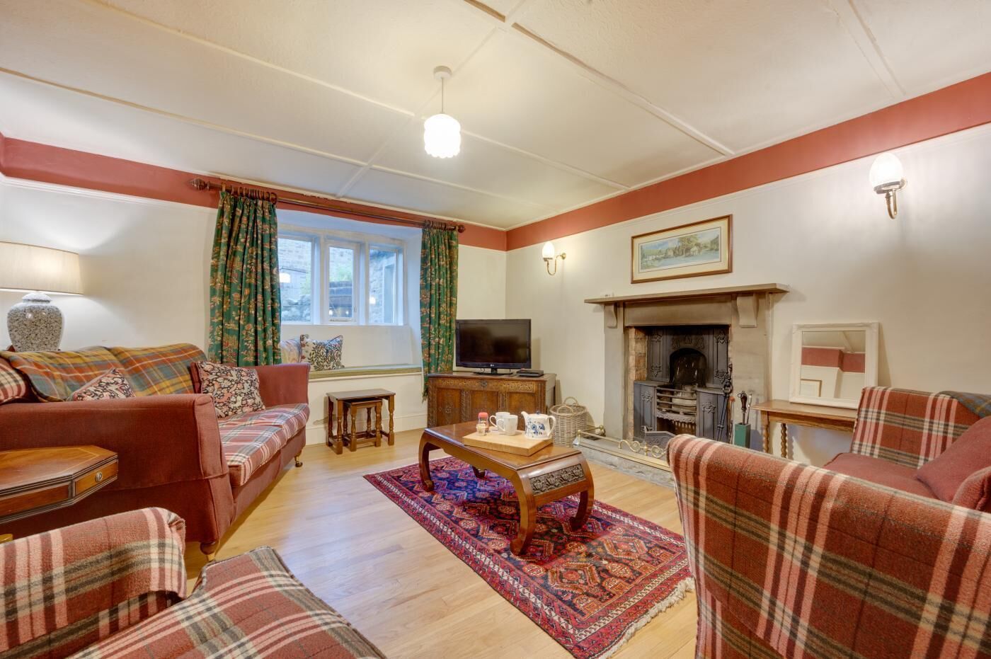 A cozy living room with a fireplace, a television, and comfortable seating.