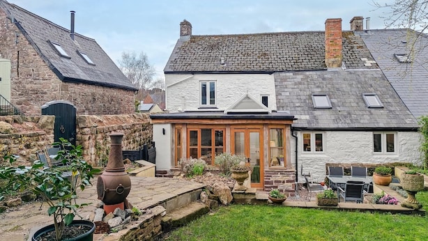 A stone house with a garden patio, a chimney, and a large pot. - 3 Bed in Trellech (oc-j34206) (Trelleck)