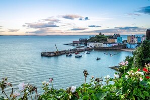 A coastal town with a harbor, boats, and colorful buildings. - 1 Bed in Tenby (oc-pw9282) (Tenby)