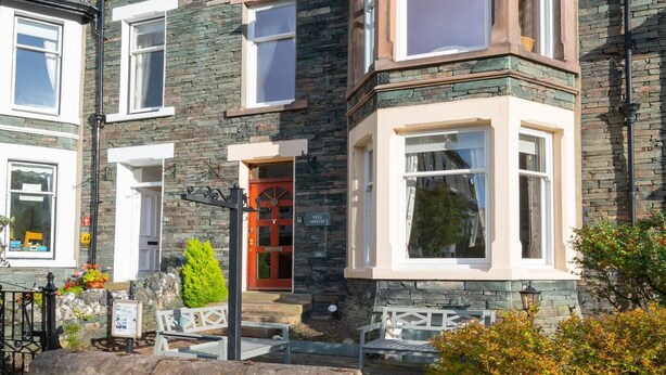 A multi-story building with stone facade and multiple windows, featuring a prominent bay window on the second floor. - 6 Bed in Keswick (oc-ld177) (Keswick)