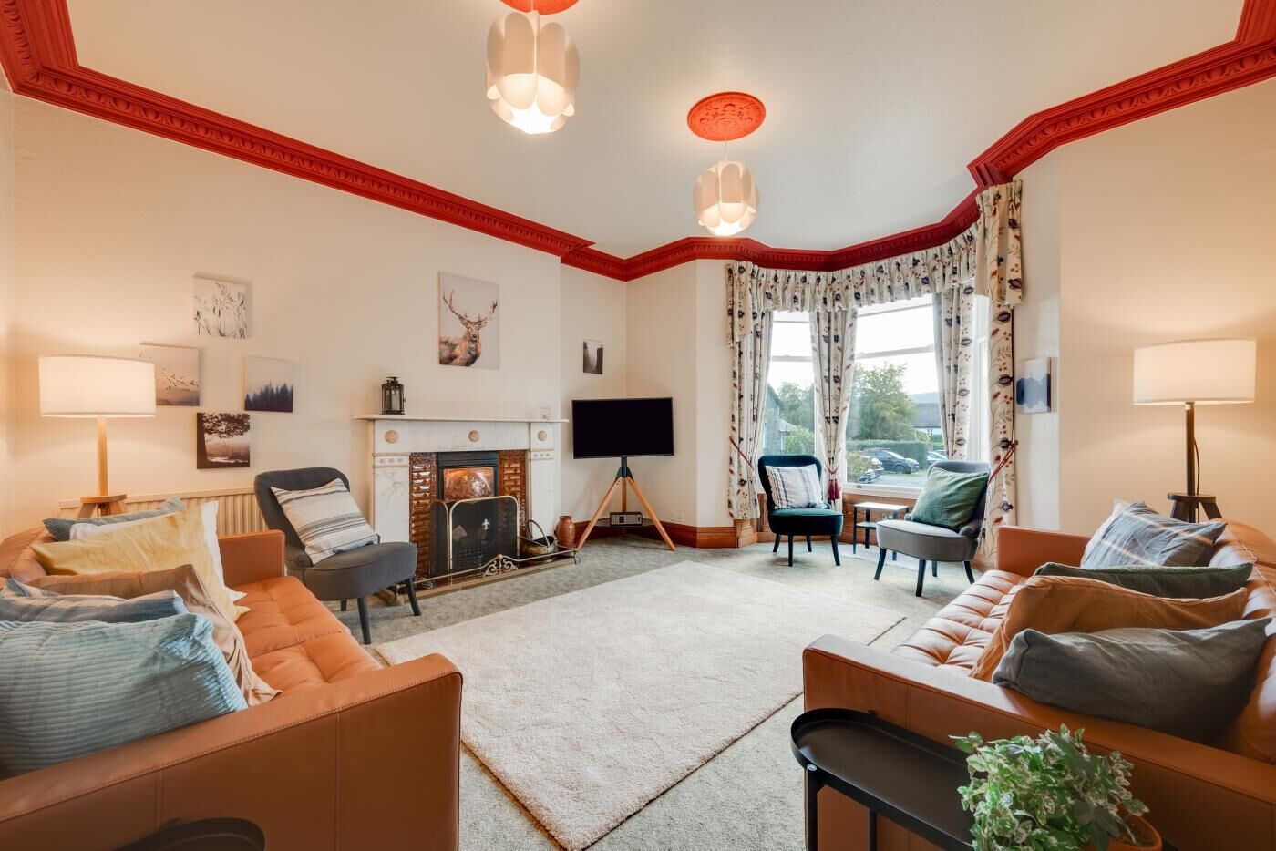A cozy living room with a fireplace, comfortable seating, and a television.