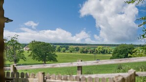 A rural landscape with a wooden fence, trees, and a distant house. - 2 Bed in Sledmere (oc-ey103) (Sledmere)
