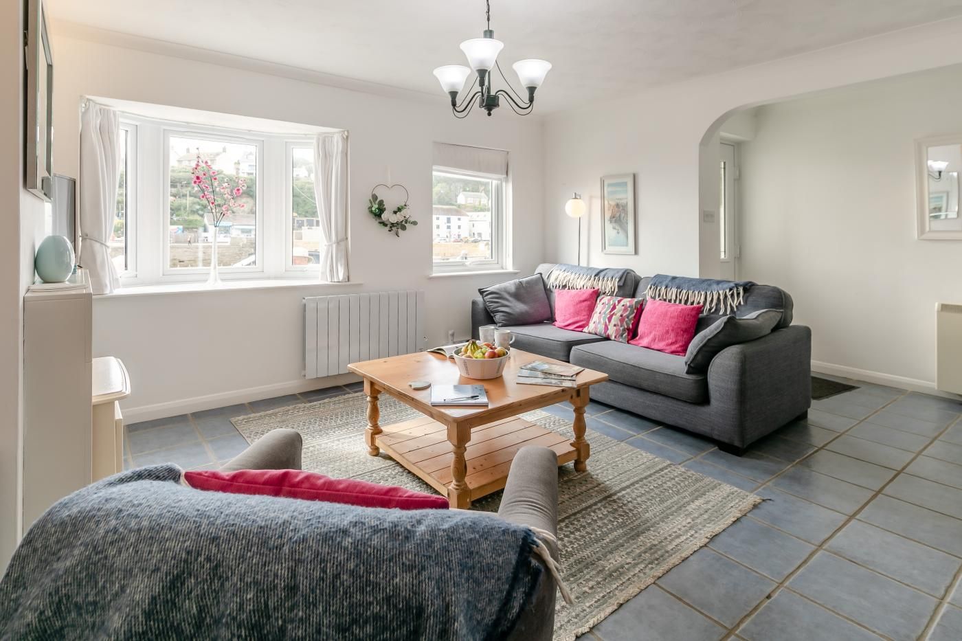 A living room with a sofa, a coffee table, and a rug.