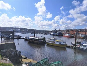 A harbor with various boats docked, a bridge, and buildings in the background. - 1 Bed in Whitby (oc-d27454) (Whitby)