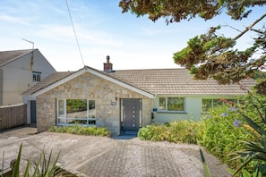 A stone house with a tiled roof, a front door, and a small porch area. - 4 Bed in St. Levan (oc-b27515) (Saint Levan)