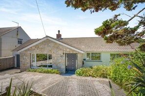 A stone house with a tiled roof, a front door, and a small porch area. - 4 Bed in St. Levan (oc-b27515) (Saint Levan)