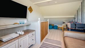 Ein gemütliches Zimmer mit Spielecke, inklusive Tischfußball und Spielkonsole.
