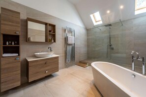 A modern bathroom with a freestanding bathtub, a glass-enclosed shower, and a vanity with a vessel sink. - 3 Bed in Okehampton (oc-h27530) (South Tawton)