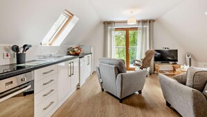 A modern apartment with a kitchen, dining area, and living room. - 2 Bed in Eccles (oc-l27507) (Eccles)