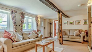 A living room with two sofas, a coffee table, and a fireplace. - 2 Bed in Weybourne (oc-b16181) (Weybourne)