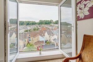 A room with a large window offering a view of a residential area. - 3 Bed in Mumbles (oc-t27675) (The Mumbles)