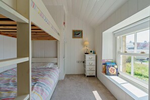 A bunk bed room with a window, a desk with a lamp, and a bookshelf. - 4 Bed in Beadnell (oc-b27650) (Beadnell)