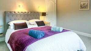 A neatly made bed with a purple blanket, a blue towel, and a white comforter. - 2 Bed in Gimingham (oc-h27869) (Gimingham)