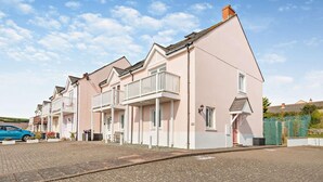 A row of two-story houses with a paved driveway and a blue car parked in front. - 3 Bed in Broad Haven (oc-p27926) (Broad Haven)