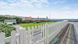 A private garden with a white picket fence, a bench, and a sign indicating it is for use by St. Brides Bay View residents only. - 2 Bed in Broad Haven (oc-s27911) (Broad Haven)