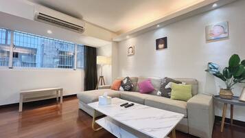 A modern living room with a sofa, a coffee table, and a bench.