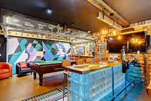 A bar area with a pool table, bar stools, and a variety of bottles and glasses. - 5 Bed in Tavistock (oc-m28107) (Tavistock)