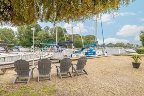 A marina with boats docked, a covered area, and outdoor seating.