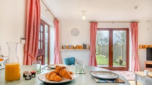A breakfast table with croissants, a glass of orange juice, and jam jars. - 2 Bed in Barnby (oc-t28265) (North Cove)