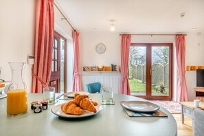 A breakfast table with croissants, a glass of orange juice, and jam jars. - 2 Bed in Barnby (oc-t28265) (North Cove)