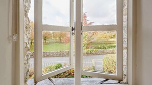 A double door leading to an outdoor area with a stone wall and a grassy field with trees. - 2 Bed in Maentwrog (oc-g28262) (Maentwrog)