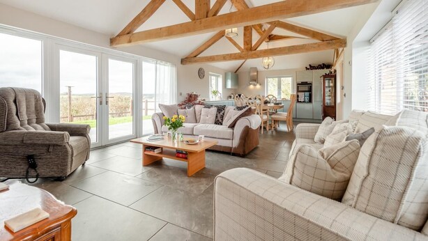 A spacious living area with a high ceiling, large windows, and a view of the outdoors. - 2 Bed in Chalbury (oc-t28279) (Horton)