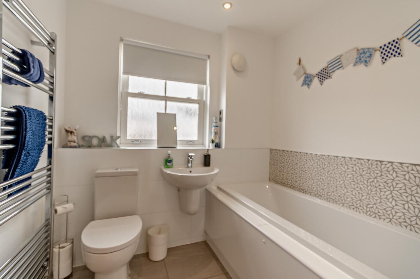 A bathroom with a toilet, sink, and bathtub.