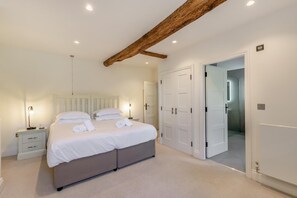 A bedroom with a bed, bedside tables, a wardrobe, and a door leading to another room. - 6 Bed in Newby Bridge (oc-h28386) (Newby Bridge)