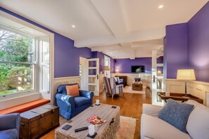 A modern living room with a fireplace, seating area, and a television. - 6 Bed in Newby Bridge (oc-h28386) (Newby Bridge)