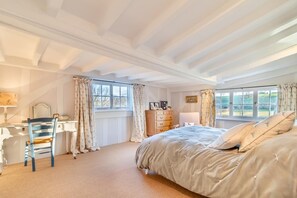 A bedroom with a large bed, a desk, a chair, and a dresser. - 3 Bed in Monk Soham (oc-h28366) (Monk Soham)