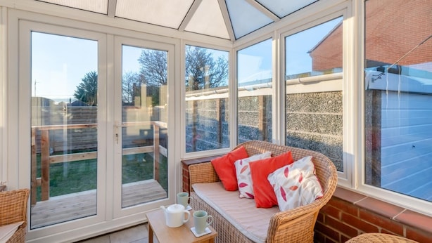 A sunroom with a glass ceiling, wicker furniture, and a view of the backyard. - 2 Bed in Holt (oc-r28378) (Holt)