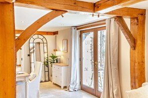 A room with a wooden ceiling, a white dresser, a mirror, and a sliding glass door leading to an outdoor area. - 4 Bed in Nottage (oc-t28401) (Nottage)