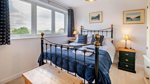 A bedroom with a bed, bedside tables, a nightstand, a window, and a view of the outdoors. - 2 Bed in Hudswell (oc-w28429) (Hudswell)