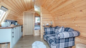 A cozy cabin interior with a kitchenette, a sofa, and a fluffy rug. - 1 Bed in Crediton (oc-p28229) (Crediton Hamlets)