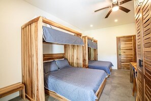 A room with two bunk beds made of wood, a ceiling fan, and a wooden wardrobe. - Luxury Villa w Pool: Beach Club, FREE Golf & Maid (Pinilla)