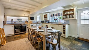 A spacious kitchen with a central island, built-in appliances, and ample storage. - 4 Bed in Craster (oc-t28831) (Dunstan)