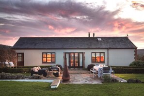 A two-story house with a patio area, a swimming pool, and a garden. - 3 Bed in Upottery (oc-t28828) (Upottery)