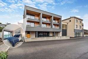 A modern multi-story building with balconies, large windows, and a flat roof. - 2 Bed in Harlyn Bay (oc-s28921) (Harlyn Bay)