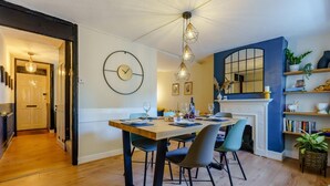 A dining area with a wooden table, chairs, and a modern chandelier. - 3 Bed in Canterbury (oc-86139) (Canterbury)